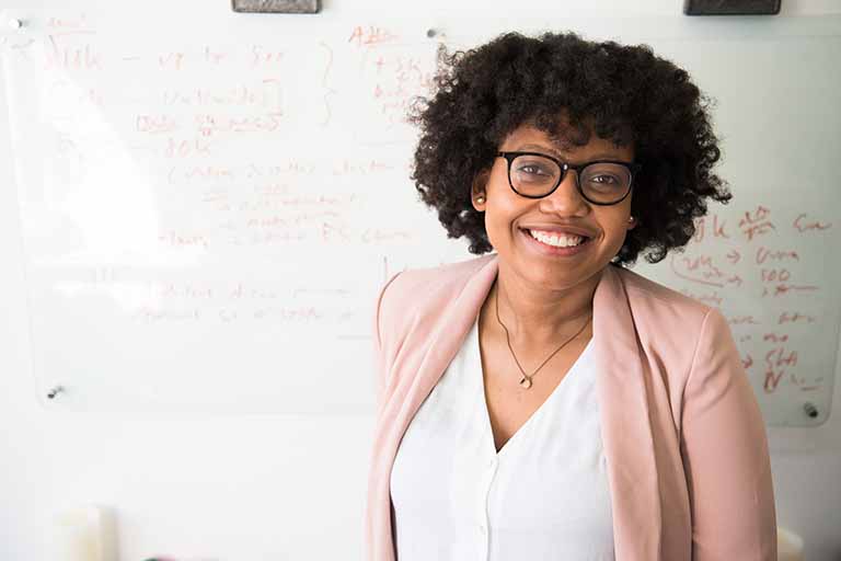 african american teacher in front of whiteboard