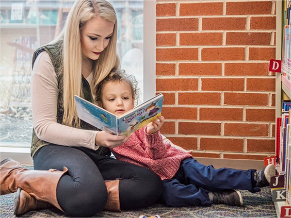 alumni reading to small child