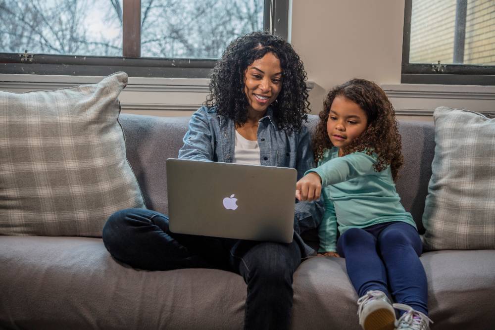 Gateway student and kid on couch