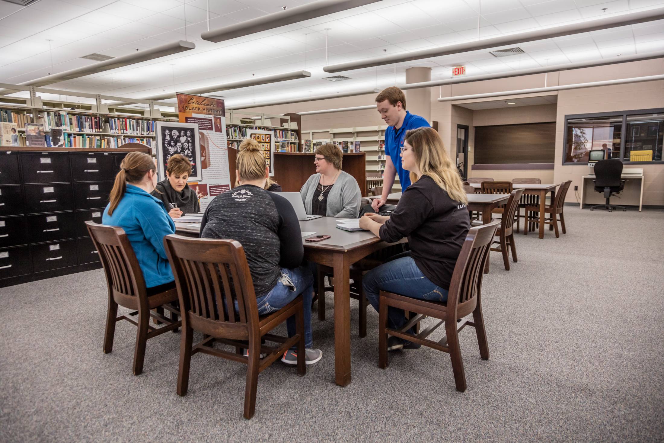 students at table in library
