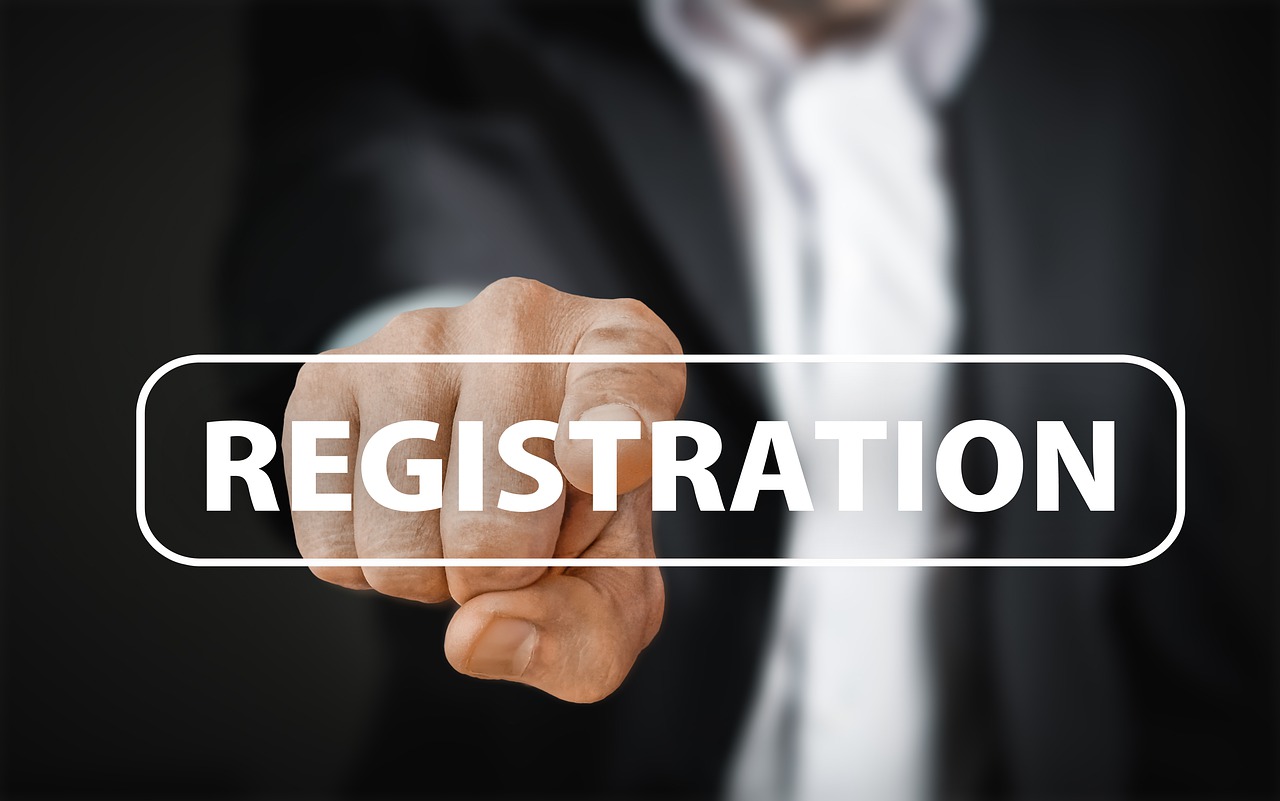 man in suit pointing at "registration"