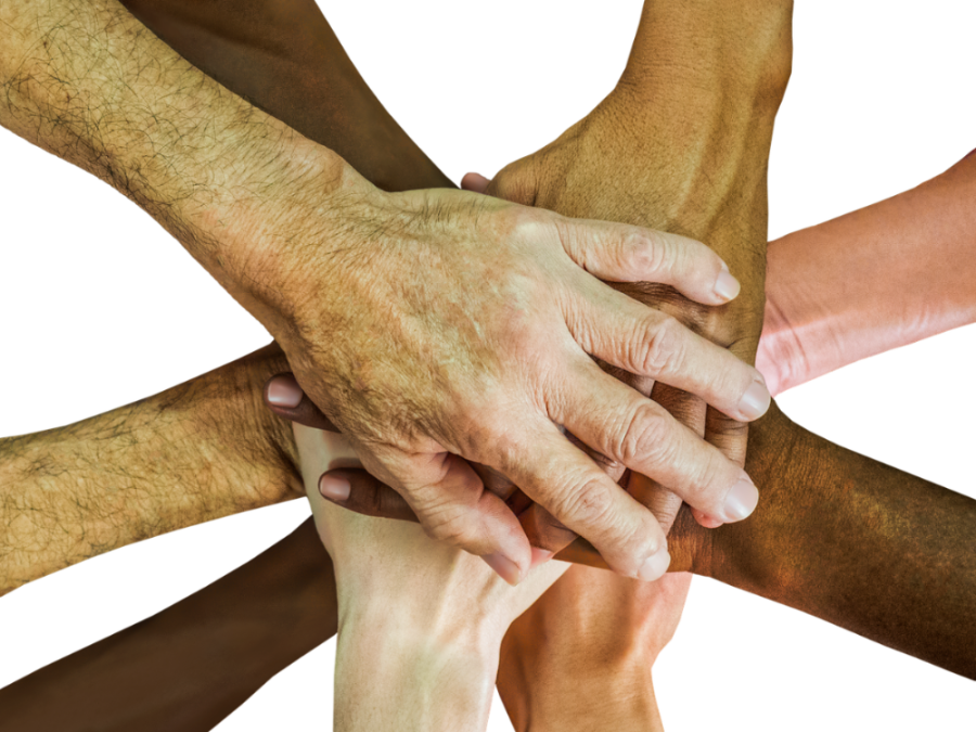 pile of hands in team handshake